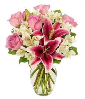 Lilies, roses and white flowers in a clear vase best seller at fastgiftz