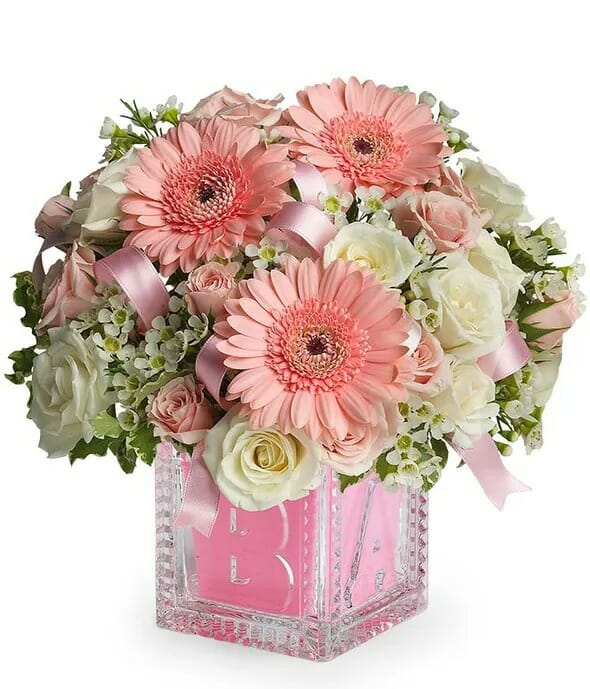 Baby's First Block Pink - A charming pink floral arrangement in a keepsake block, perfect for celebrating the arrival of a new baby girl. Expertly crafted by our talented florists for all occasions.