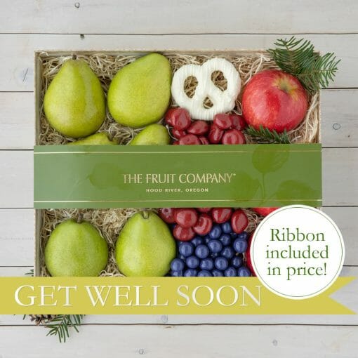 A keepsake box with pears, apples, grapes and chocolate covered pretzels.