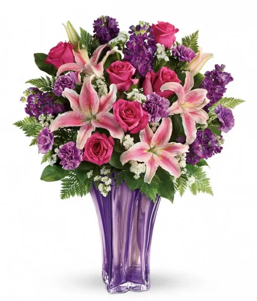 A beautiful bouquet of flowers in a lavender vase