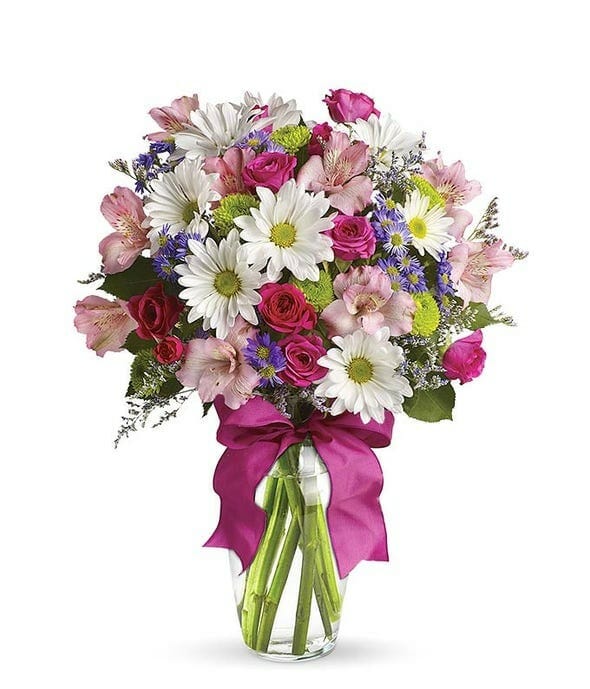 A beautiful flower arrangement with white daisies, pink roses and red carnations