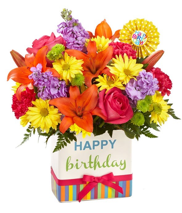 Birthday bouquet of brightly colored flowers in a happy birthday box.